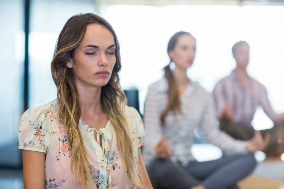 Woman and others meditating