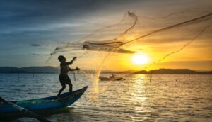 young boy in fishing boat sunset