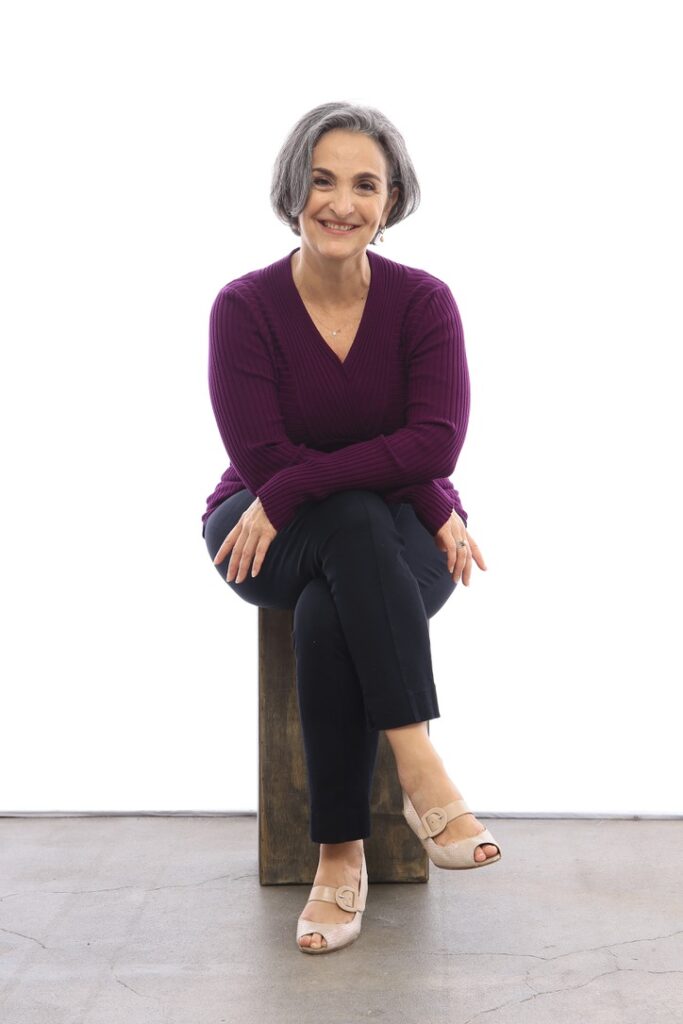 Terre sitting on a stool, legs crossed