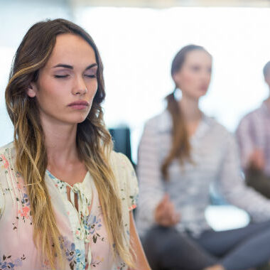 Woman and others meditating